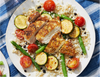 Beautifully seasoned chicken on a bed
of pearl couscous, cherry tomatoes,
green beans, and zucchini