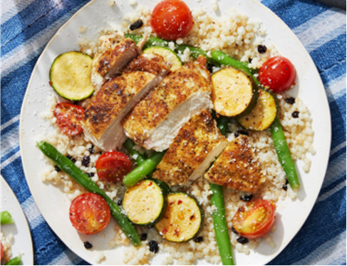 Beautifully seasoned chicken on a bed
of pearl couscous, cherry tomatoes,
green beans, and zucchini