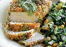 Crispy seasoned porkchops with pesto and a side of collard greens with golden raisins