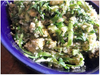 Bowl of quinoa tossed with cannellini beans, diced asparagus, cucumber, avocado and arugula in a creamy yogurt sauce
