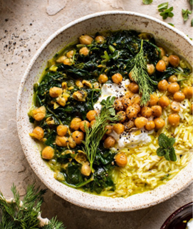 A speckled bowl with stewed herbs, rice, and chick peas 