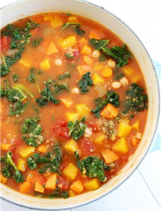 Colorful vegetable soup with quinoa, kale, butternut squash, chickpeas, quinoa, with parmesan cheese